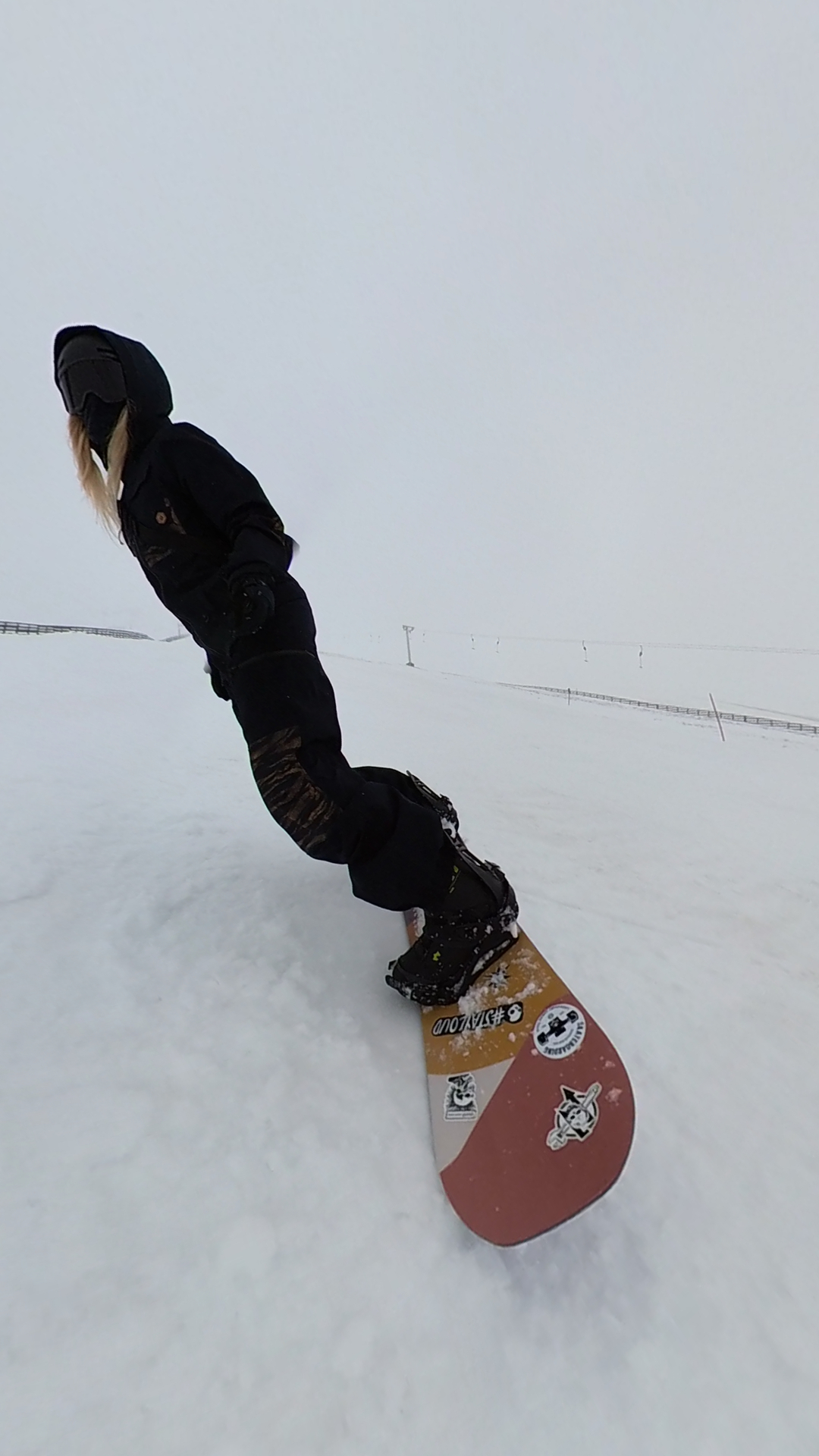 Snowboarding down a foggy run